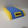 I-19917 Nikon Camera Lens Display Stand Vintage Blue Yellow Plastic Unused