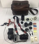 Minolta X-570 Camera Bundle From Estate Sale. 2 Tele-converters, 3 Lenses, Bag. Fixed Price $125.00.