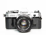 Canon AE-1 35MM Slr Film Camera W/ 50MM F1.8 Lens Tested & Working. Fixed Price $159.99.